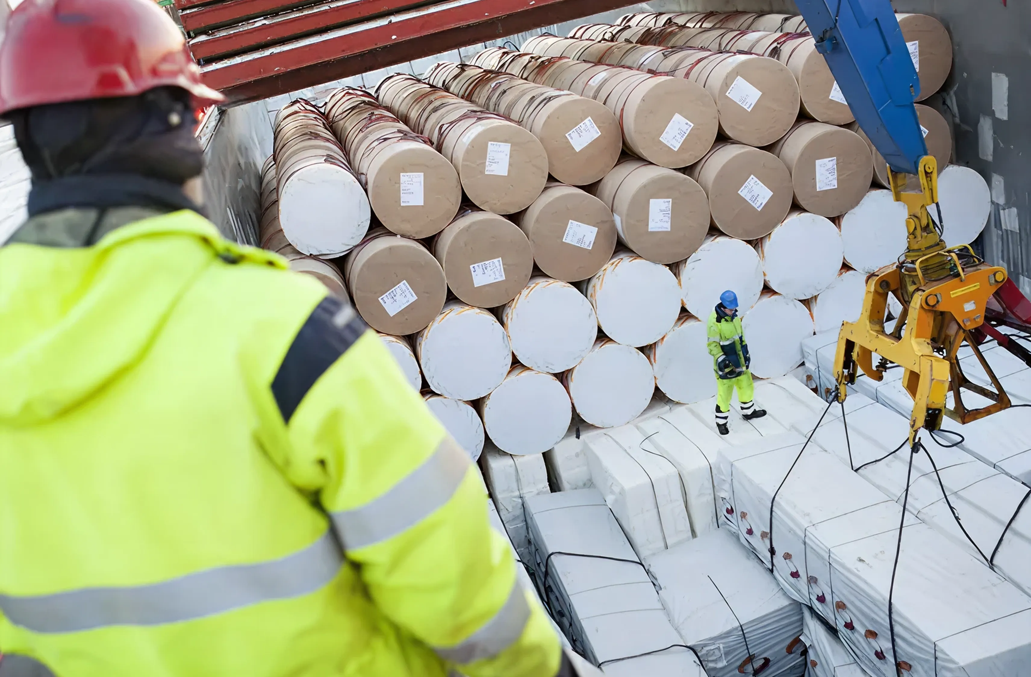 Reels of paper being lifted off the quay