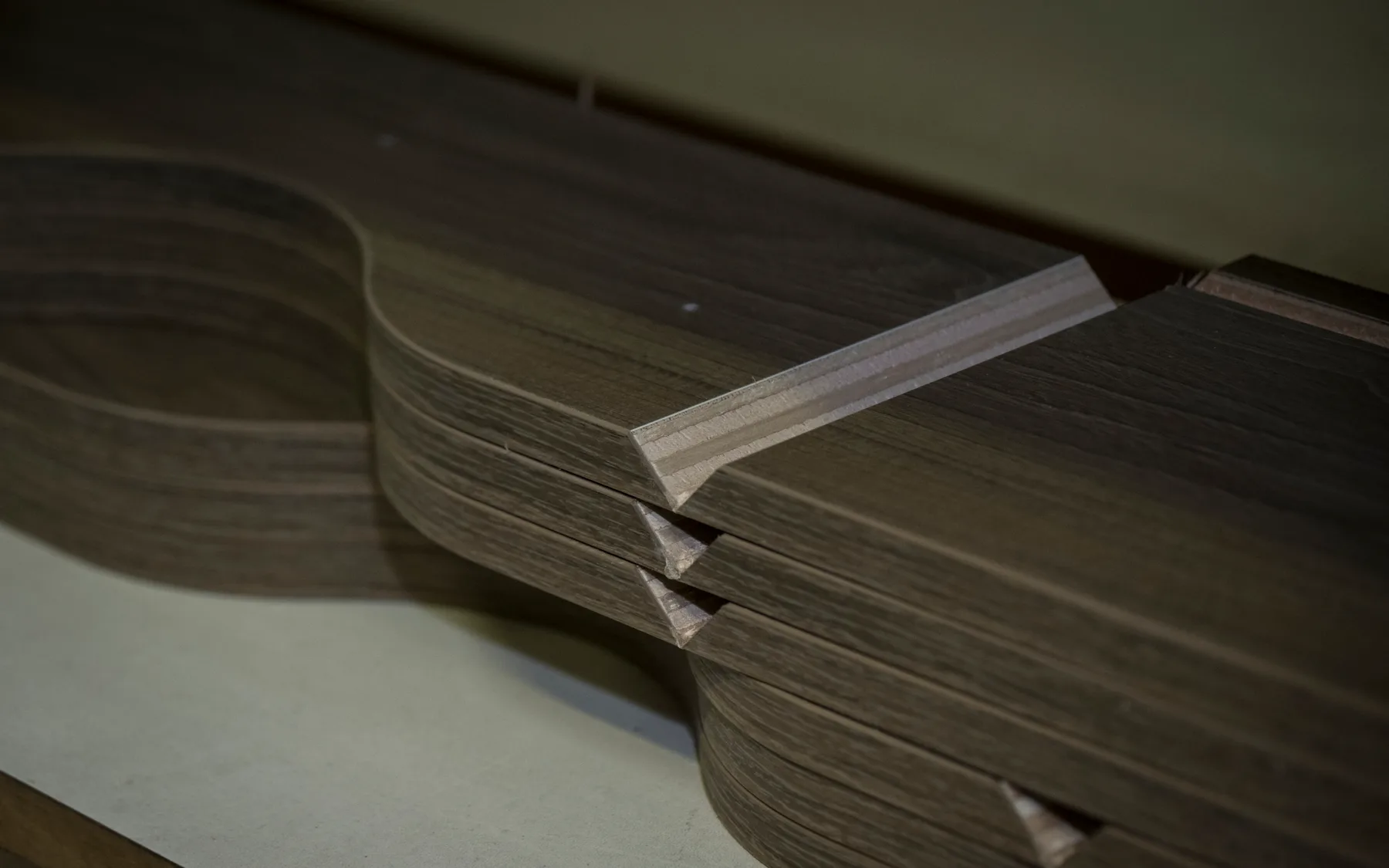 The edge of a curved laminated panel, showing the layers