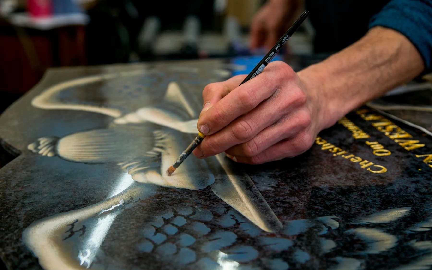 Gilding a carved design by hand