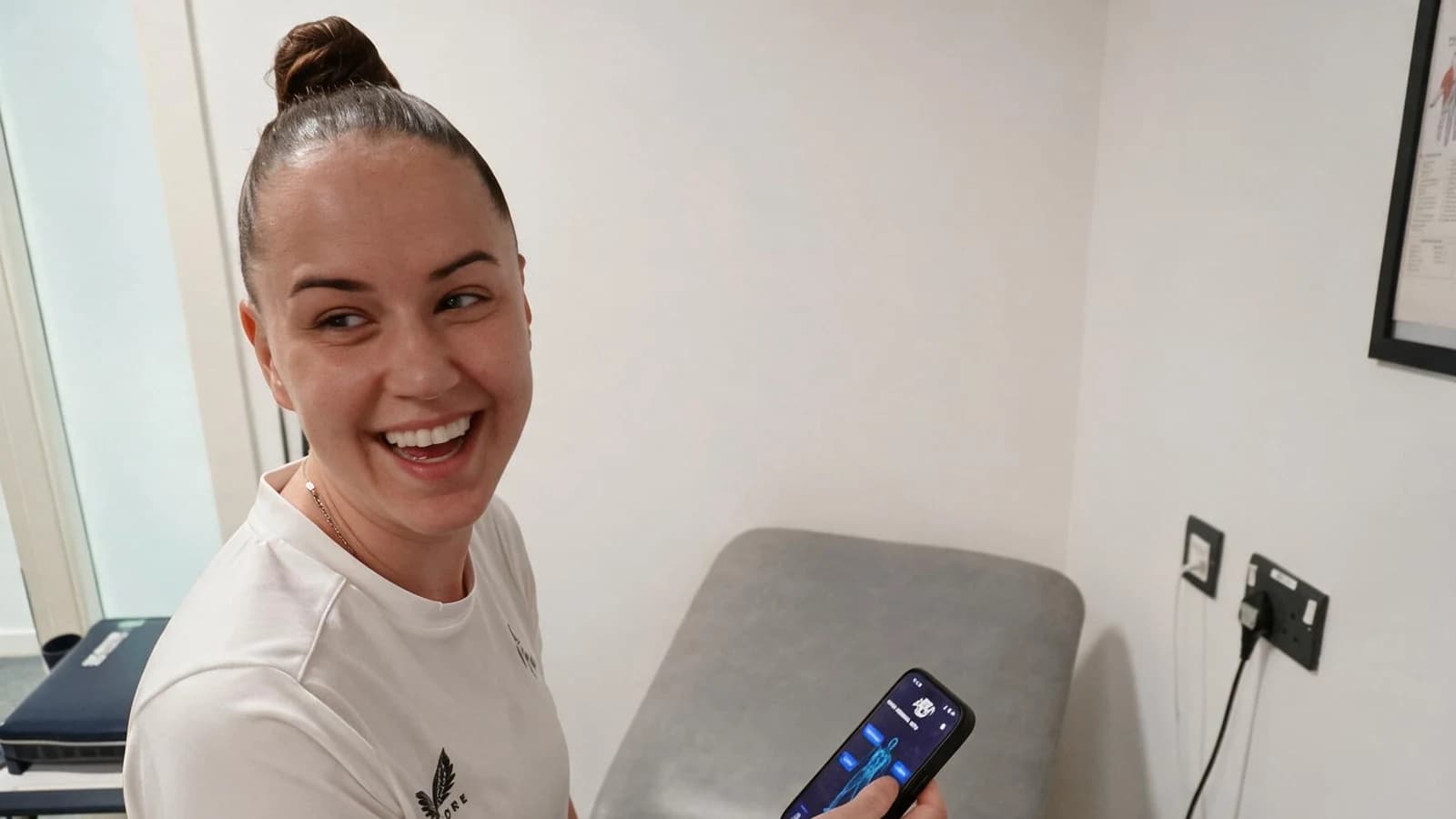 A practitioner using the app in a treatment room