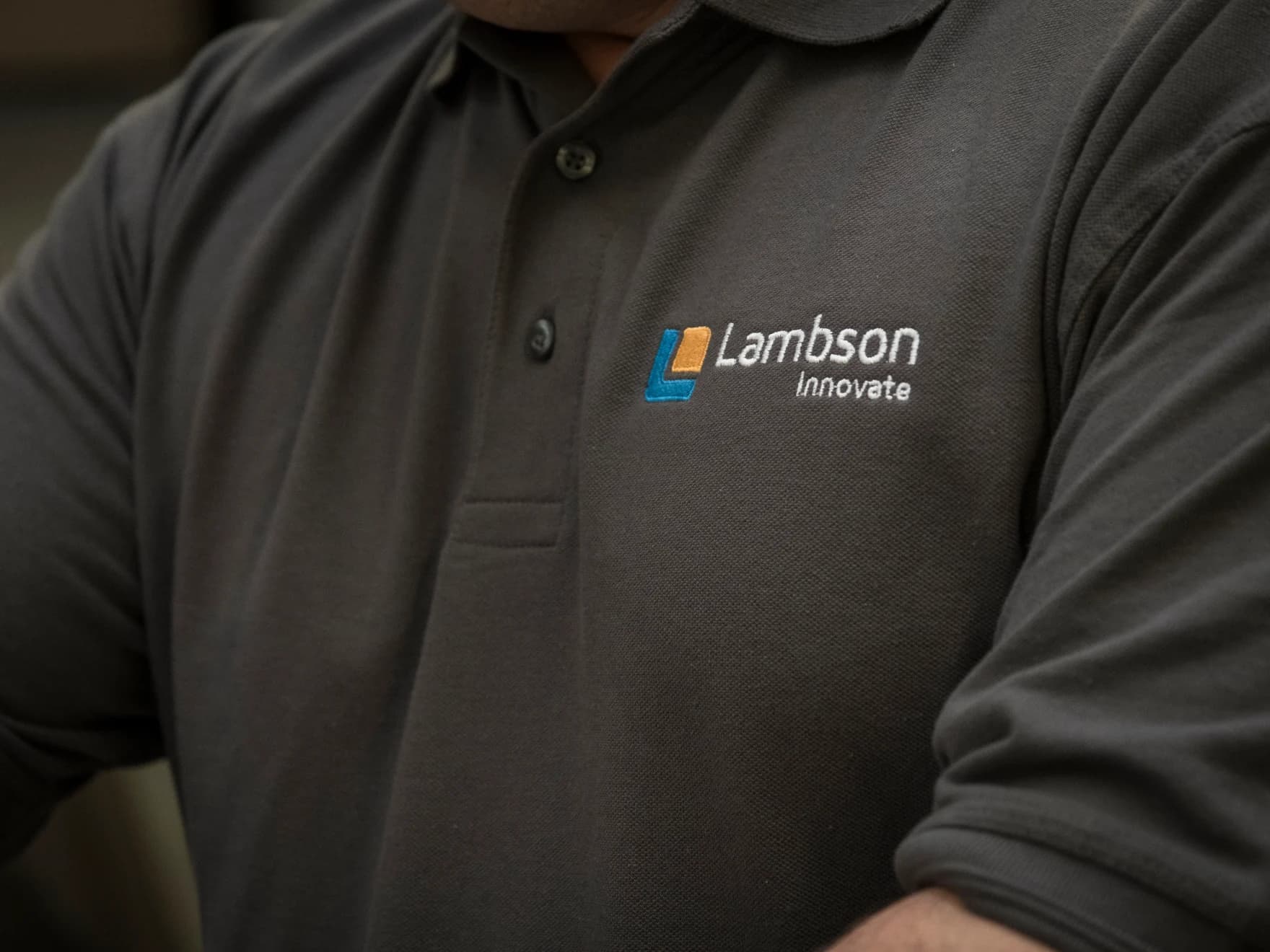 The Lambson Innovate mark embroidered on a work polo shirt