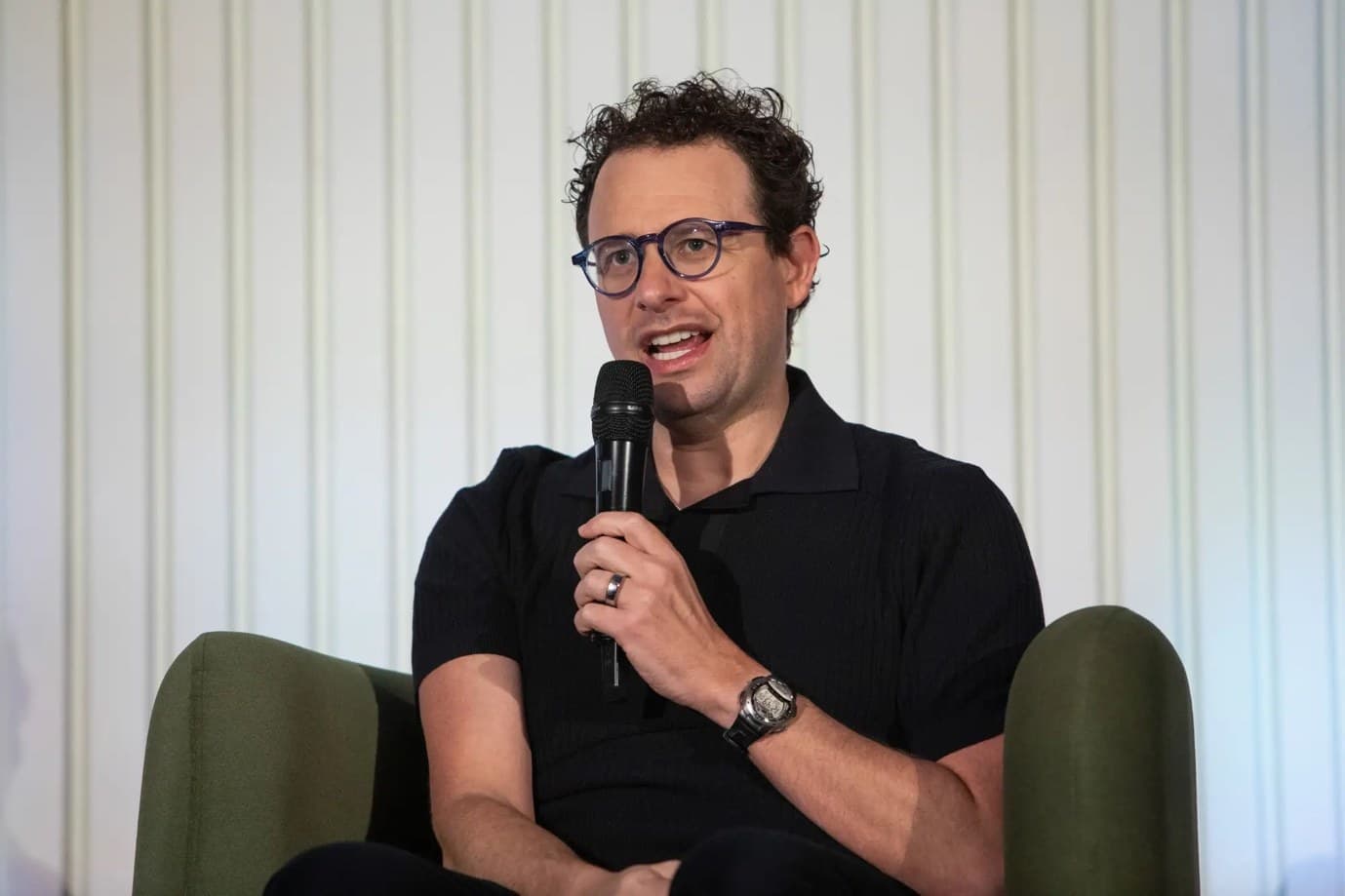 Anthropic chief executive Dario Amodei speaking with a microphone at an event.
